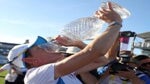 woman drinks from trophy