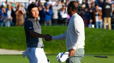 Collin Morikawa shakes hands with Tiger Woods on the 18th hole on the South Course during the second round of the Farmers Insurance Open golf tournament at Torrey Pines Municipal Golf Course on January 24, 2020.