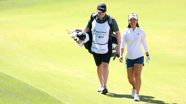 Danielle Kang walks down the fairway with her caddie, Oliver Brett.