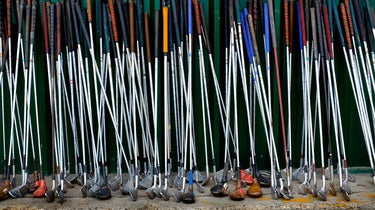 golf clubs leaning on a wall