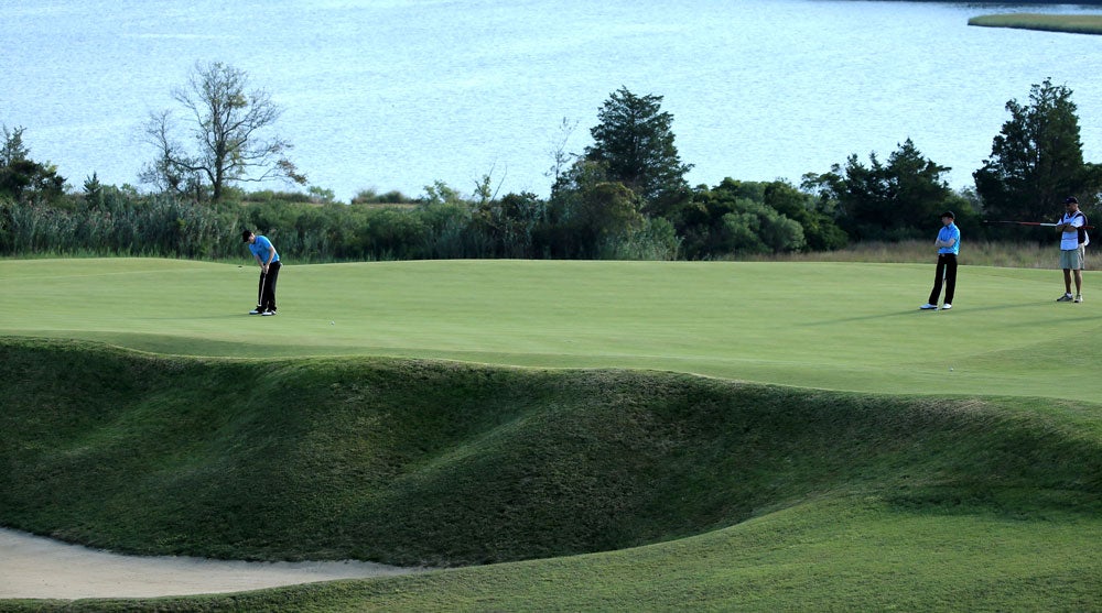 The 4th at National, where a deep bunker guards the front-left side of the green.