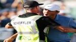 Scottie Scheffler of the United States and caddie Ted Scott celebrate winning on the 18th green during the final round of the WM Phoenix Open at TPC Scottsdale on February 12, 2023 in Scottsdale, Arizona.