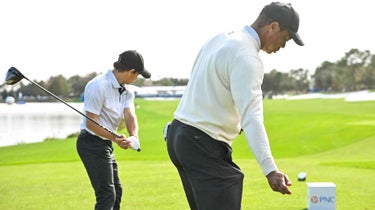 Tiger and Charlie Woods practice swing