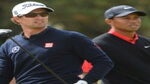 Adam Scott and Tiger Woods watch a shot.