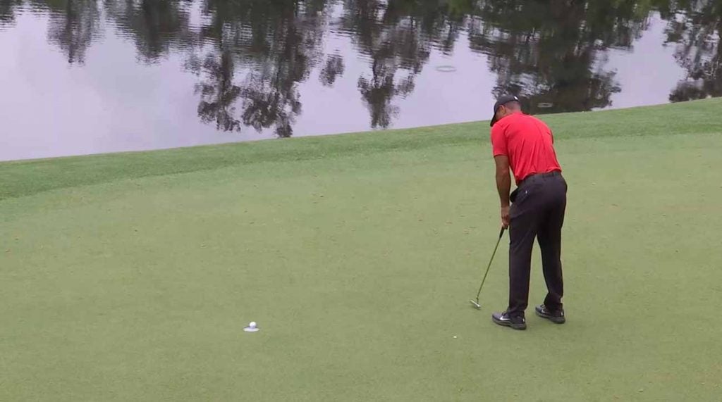 That putt on No. 12 stayed up — barely — and Woods was suddenly tied for the lead.