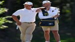 Tom Kim of South Korea and the International Team waits with caddie Joe Skovron on the ninth green during Saturday afternoon four-ball matches on day three of the 2022 Presidents Cup at Quail Hollow Country Club on September 24, 2022 in Charlotte, North Carolina.