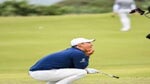 Tom Kim of South Korea reacts with his caddie Joe Skovron after nearly holing a chip shot to the 13th hole green during the final round of the Genesis Scottish Open at The Renaissance Club on July 16, 2023 in North Berwick, Scotland.