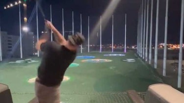 mike torut hitting drive at topgolf