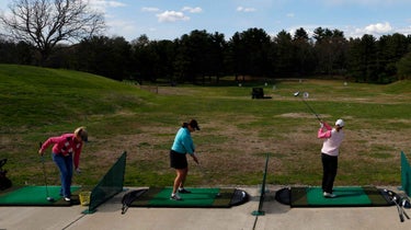 women on driving range